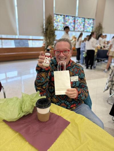 A resident is pleased with his snowman from the raffle.