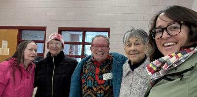 A group smiles before they head into dinner.