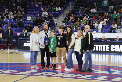 Matt Trahan poses with his family at the Tsongas Center in Lowell after being honored for receiving the Sherman A. Kinney Award in 2024. Photo by Liam Mayo