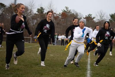 An Old Rochester player runs with the ball past Wareham’s defense during the annual Powderpuff football game on Tuesday, Nov. 21. Photos by Sawyer Smook-Pollitt
