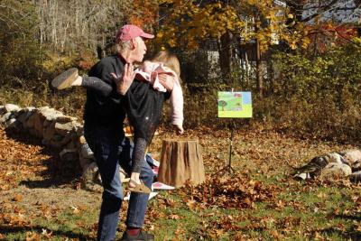 Vera volunteers to be tossed into a pile of leaves.