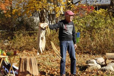 Gillman shows the audience how an apple picking sack functions.