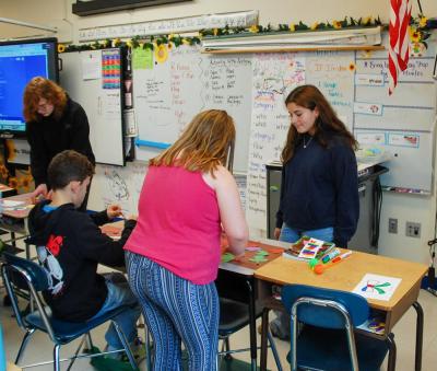 Bridget Coryer helps students with their crafts.