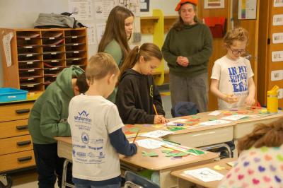 High schoolers help out some younger students.