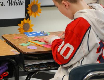 Multiple pieces of colored paper were used to tape and glue the wreath together.