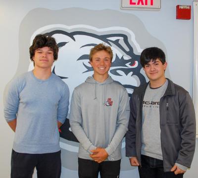 James Russell, Luke Pierre and Rafael Duarte, 3 class officers who created the cookbook, pose infront of an Old Rochester Bulldog. Photo by Mari Huglin