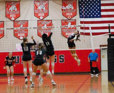 Molly Franco leaps to spike the ball. 