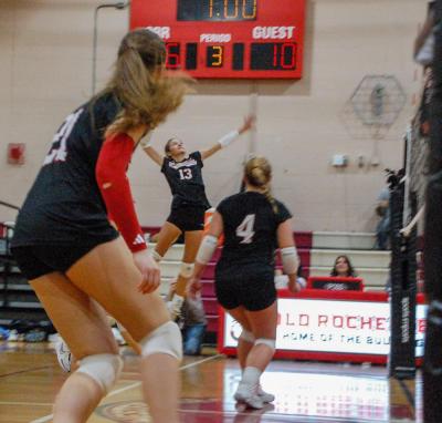 Molly Franco leaping to hit a ball.