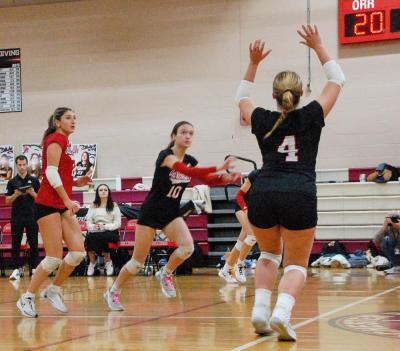Molly Morrison sets the ball as Hadley King gets ready to jump and spike.