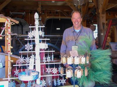 A Red Oak Garden volunteer smiles in front of his table.