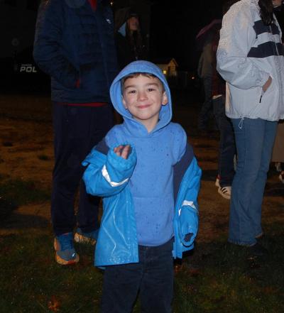 One child smiles excited for the tree to be lit.