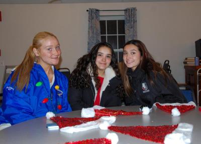 3 girls smile as they enjoy the festivities.
