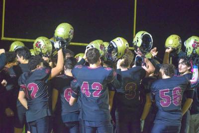 The team celebrates at the end of the game. 
