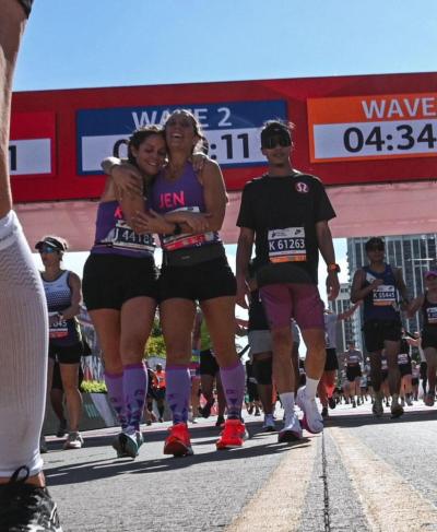 Pease crossing the Finish line of the Chicago Marathon in October of 2024 with her running partner, Kristen Wingate.