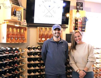 Joel Sullivan of Rochester and Niki Ashley stand together in J. Sull Wine, a new business they opened, in Marion. Photo by Grace Ann Natanawan