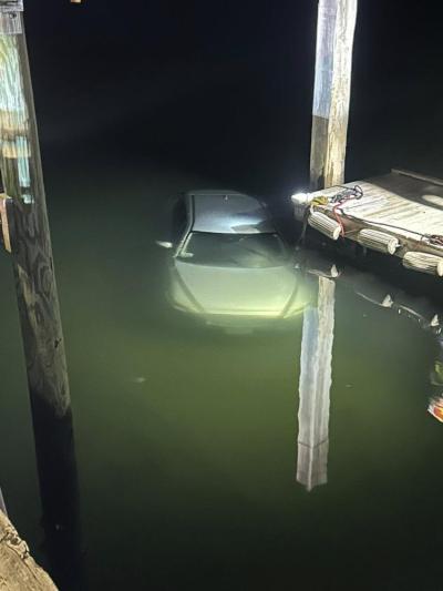 The car was 100 feet into the harbor when the Fire Department arrived.