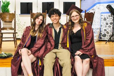 Culinary graduates and Lakeville residents Emily Silvia, Duncan Matterazzo and Abigail Dawicki smile together at Old Colony Regional Vocational Technical High School graduation. Photo by Grace Ann Natanawan