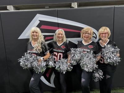 Elaine Botelho poses with the other cheerleaders from the original 1966 team.
