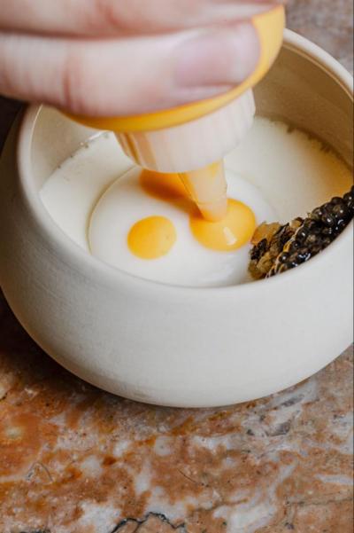 The finishing touches are put on a shiitake mushroom custard with saffron, parsnip, and sustainably-harvested caviar. Photo source: Victoria Quirk