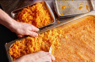 Doubrava scrapes sea buckthorn granita, a citrusy frozen dessert. Photo source: Simione Rusnak