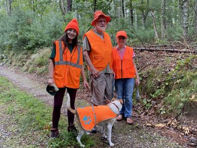 Group of hikers and their dog wear orange during hunting seaso. File photo