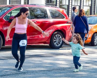 Kristie Simmons of Freetown reaches for her daughter’s hand at a Mother’s Day 5k on Sunday, May 11 in Mattapoisett. Photo by Abby Van Selous