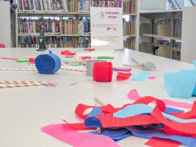 Streamer wands cover one of the tables in the library. 