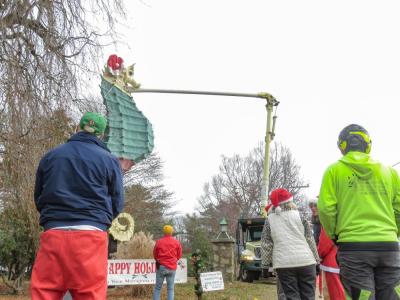 Community members look on as the hat is installed. 