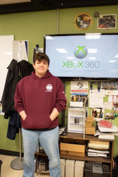 Tyler Moskos in front of his Xbox connected to a TV. 