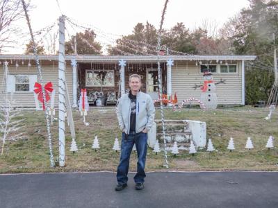 Carrier stands in front of his decorated home. Photo by Grace Roche