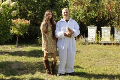 Rochester residents Miah Motta and her father Ryan Motta standing his beehives on their property. Photo by Grace Ann Natanawan