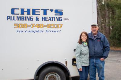 Debra Rusinoski, left, and Chet pose in front of one of their trucks outside their Marion office. Their family business closed this year after 45 years of business. Photo by Bobby Grady