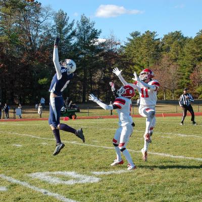 Henry Berry, center, and Quinn Chisholm, left, jump for an interception behind Connor Cyr at the Thursday, Nov. 27 in a Thanksgiving rivalry game between Old Rochester Regional High School and Apponequet High School. 