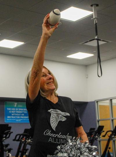 Elaine Botelho poses with a football she has had since 1966.