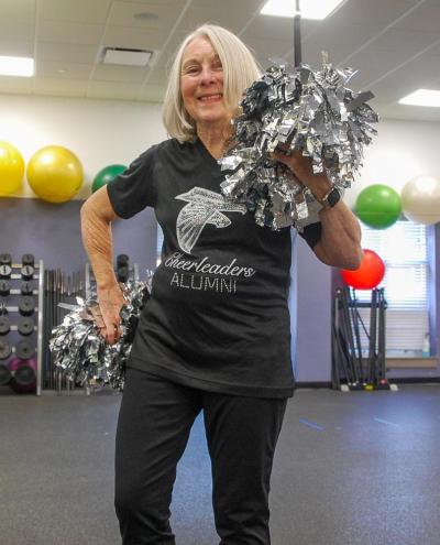 Botelho smiles with her pom poms.