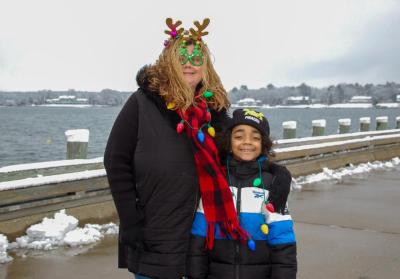 Family members smile as they wait for Santa to arrive.