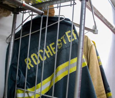 Fire uniforms are hung in the garage.