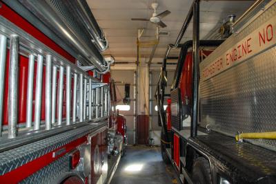 Both fire trucks parked in the fire station garage.