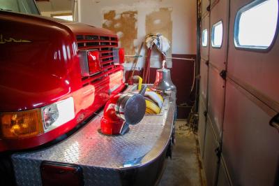 A fire truck is parked inches from the garage door.