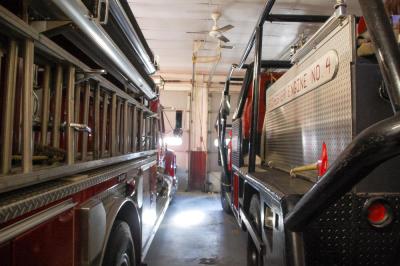 Fire engines are parked extremely close to one another.