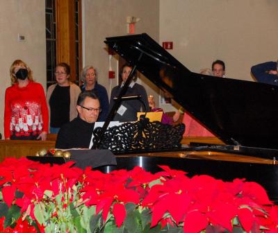 Darry Dolezal, the director, leads the group in vocal warmups.
