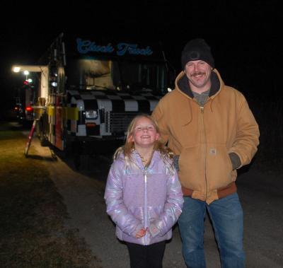 A father and daughter smile.