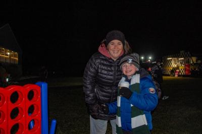 Two atendees play Connect 4 on the lawn.