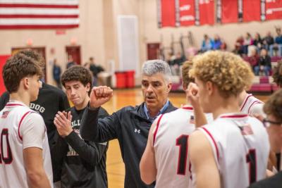 Steve Carvalho, middle, leads the Old Rochester Boys Basketball team in a pre-game speech before taking on West Bridgewater High School Friday, Feb. 14. Photo by Bobby Grady