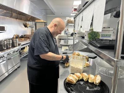 Danny Minkle working out of his kitchen at the Stone Path Malt. Minkle is from Onset and works out of Frogfoot Farm with the Marion Institute to feed people experiencing homelessness. Photo by Brandy Muz