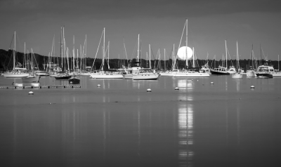 "Moonlit Sippican Harbor" showcases boats at rest in the water.