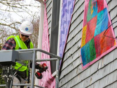 Matt Moyer Bell, Massachusetts Design, Art, and Technology Institute's programs coordinator, installs part of the “Being Seen” display outside the Marion Art Center on Wednesday, Jan. 14. Photos by Grace Roche
