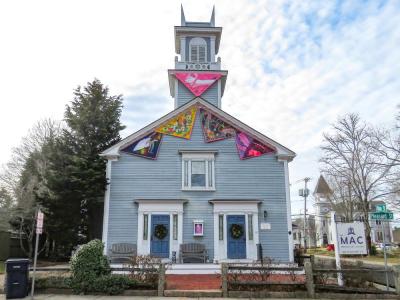 Colorful triangles of sailcloth adorn the outside of the Marion Art Center. 