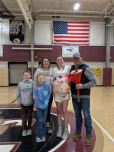 Surrounded by her family, Lila White celebrates the end of the girls basketball season. 