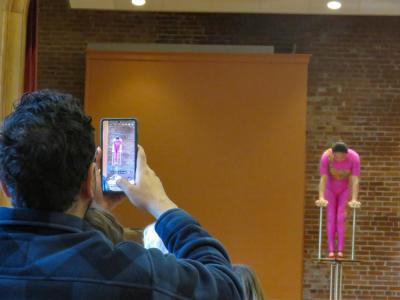 A member of the audience captures part of Liu's routine. 